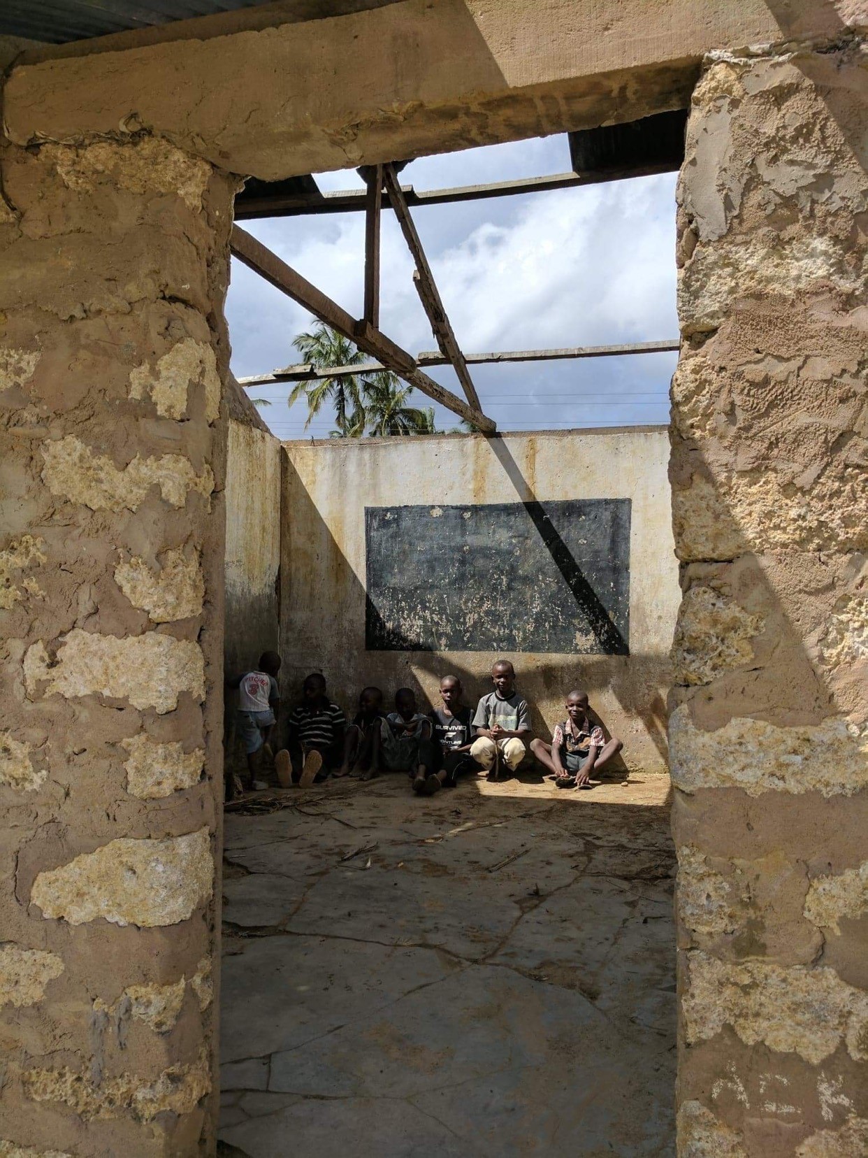 Kids from the Village of Lutsanga sitting in empty school.